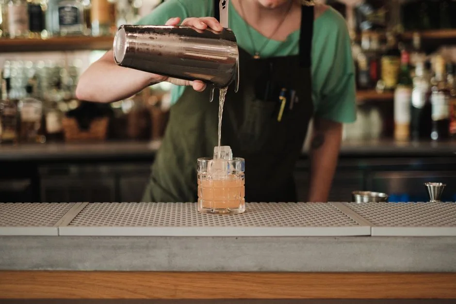 The drink is built in front of you, one at a time, at the bar.